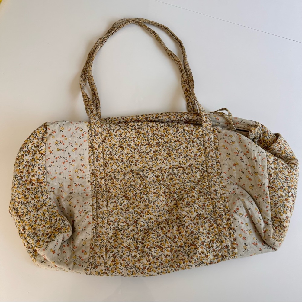 Large lightweight travel duffel with zipper closure and exterior side pocket